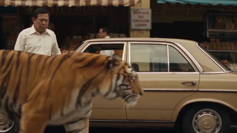 Storyboard shot 2: the tiger passes a parked vintage car